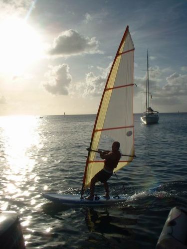 William is passing by with the wind surf he stole from a little boy, 